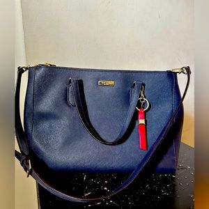 Selling this new kate spade navy blue with a red bow key chain.